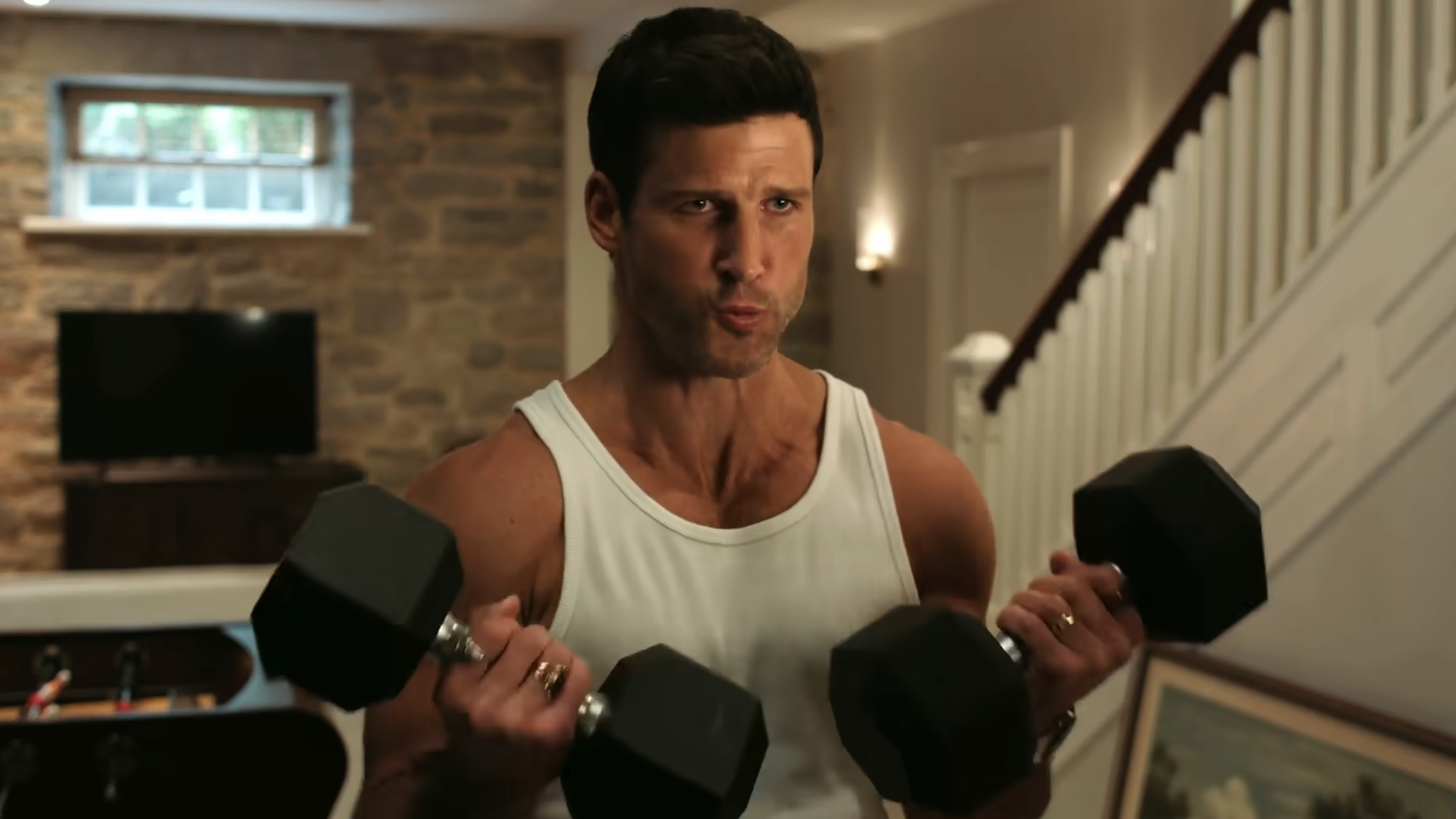 Jesse Blythe (Parker Young) lifts weights during an episode of Eternally Yours.