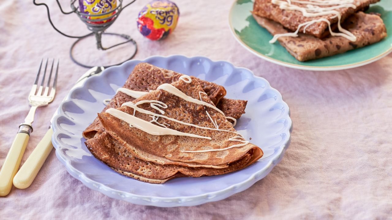 Homemade Cadbury Creme Egg pancakes on a purple plate