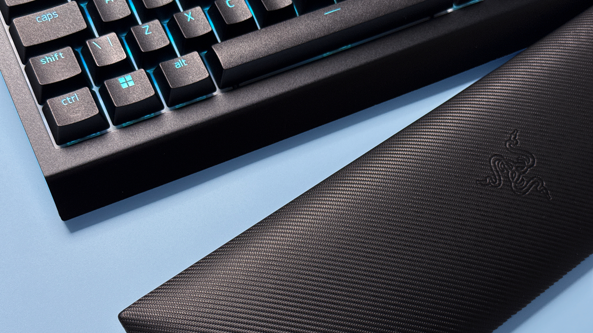 Razer BlackWidow V4 Pro 75% keyboard from various angles on a light blue background