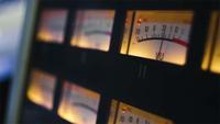 Close-up of illuminated volume unit meters in recording studio.