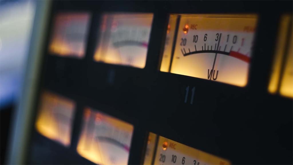 Close-up of illuminated volume unit meters in recording studio.