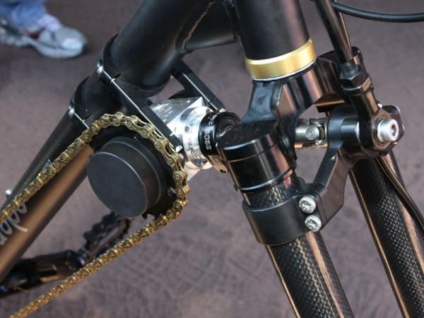 A chain connects the driver box to the crankset to help drive the rear wheel.