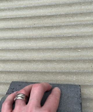 Close of up my hand whilst sanding a fluted panel