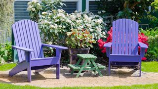 Two colorful garden chairs painted in lilac