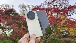 Honor Magic V5 unfolded, red tree in background