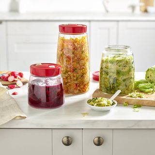 kitchen worktops with glass jars containing pickles and fermentation