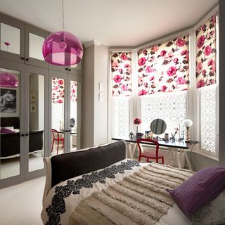 summer bedroom with pink floral blinds double bed and mirrored wardrobes