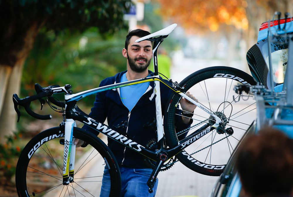 A mechanic gets the bike ready for the car
