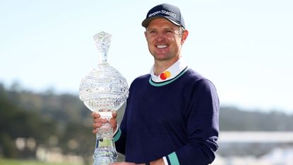 Justin Rose poses with the trophy after his win at the 2023 Pebble Beach Pro-Am