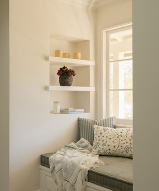 window seat with pillows and alcove shelves