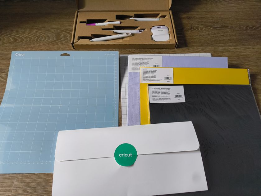 Cricut Explore 4 review: craft materials like papers on a wooden table