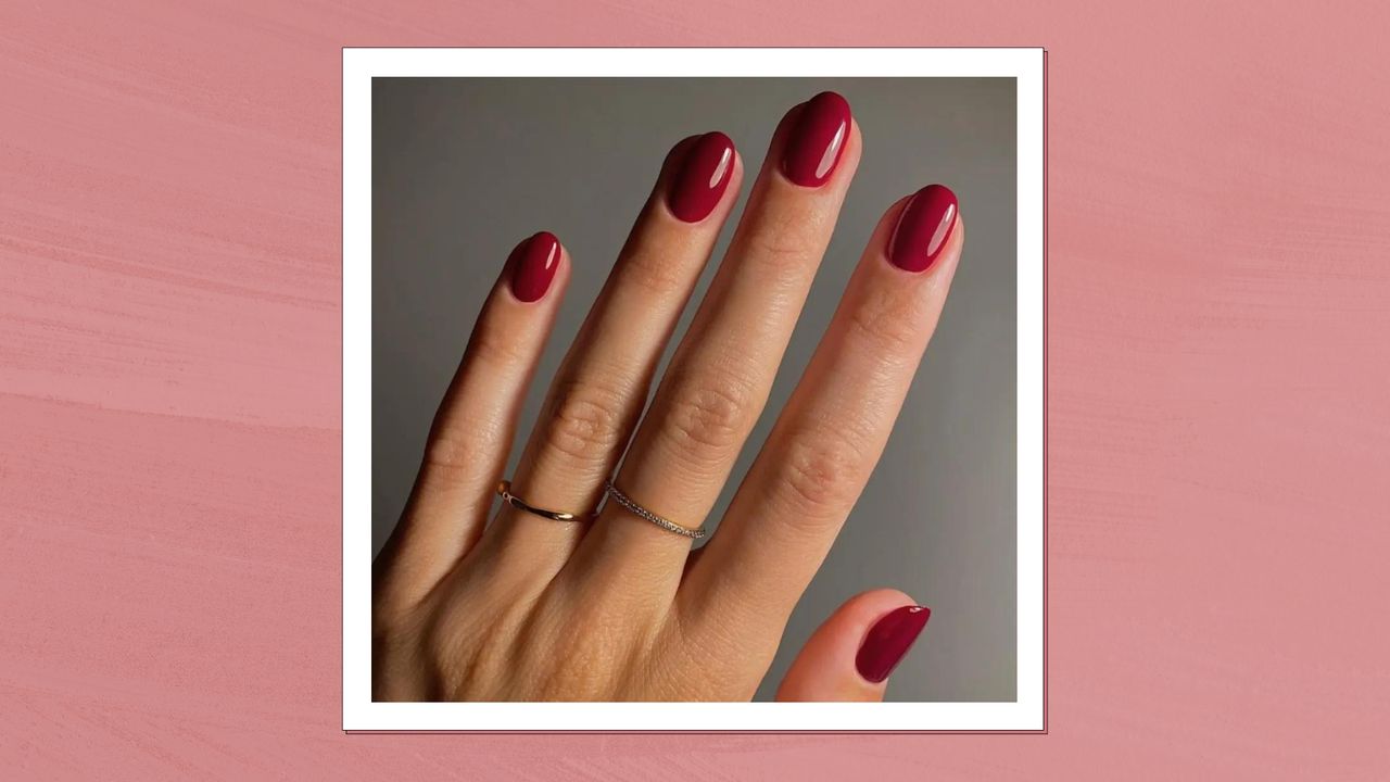 A close up of a hand with cherry red nails and wearing a few thin rings by nail artist Mateja Novakovic/ @matejanova/ in a dark pink textured template