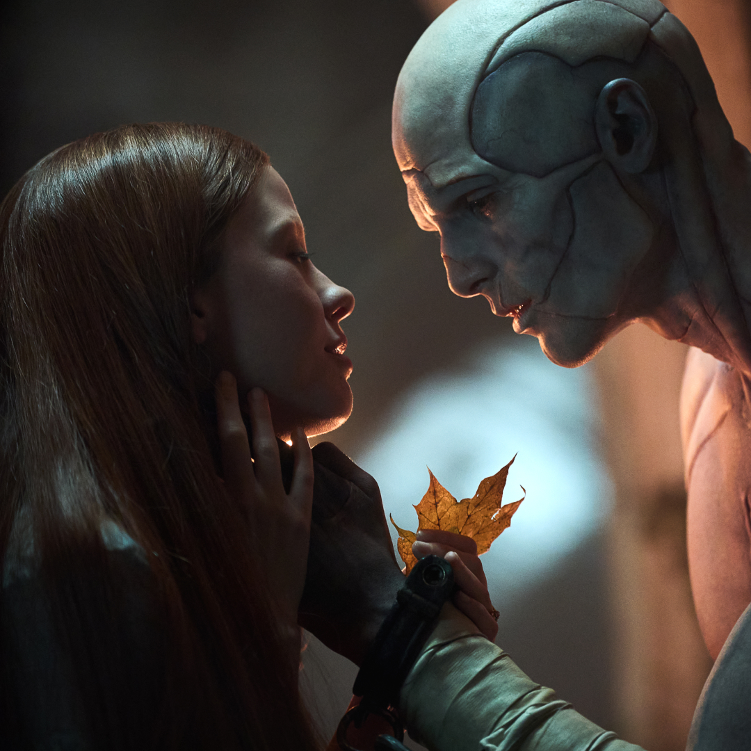 the creature caresses elizabeth's face while they examine a leaf in a still from frankenstein