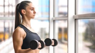 a photo of a woman doing a dumbbell bicep curl