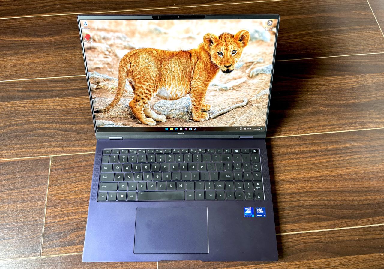 the Honor Magicbook Pro 16 sitting on a wooden floor.