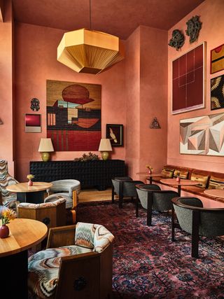 restaurant space in terracotta pink walls with art