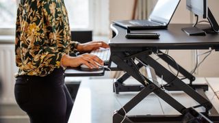 Woman using a standing desk at work