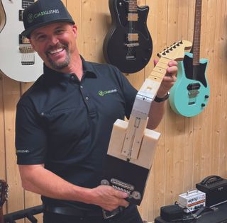 Ciari founder Jonathan Spangler holds the original prototype for the company’s folding guitar.