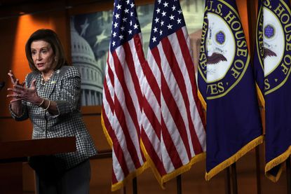Nancy Pelosi wearing an American and Ukrainian flag pin