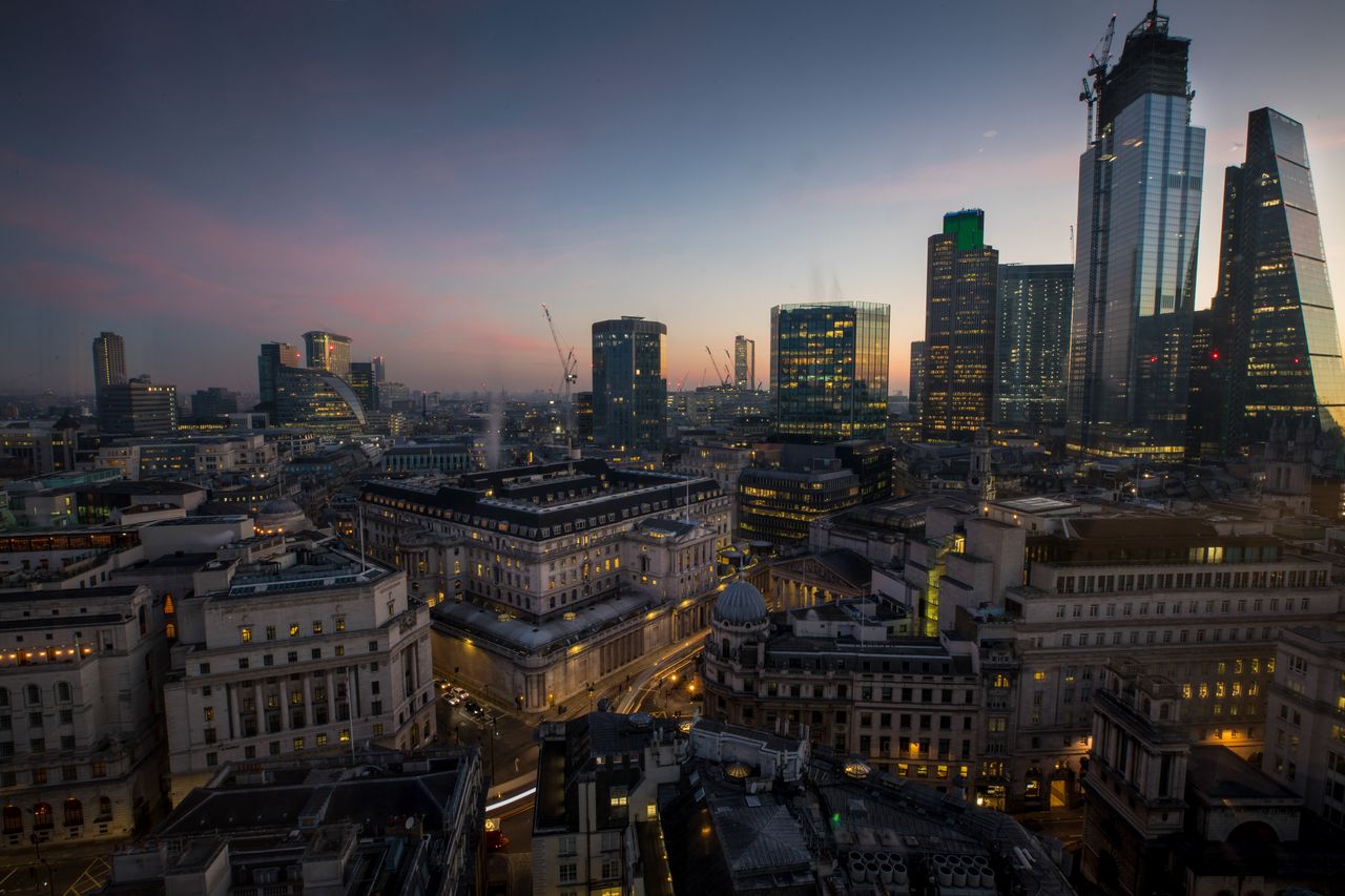 Automobiles create light trials as they pass the Bank of England (BOE), center, at dawn in the City of London, U.K., on Monday, Feb. 25, 2019. The U.K. and U.S. sought to allay fears of disru