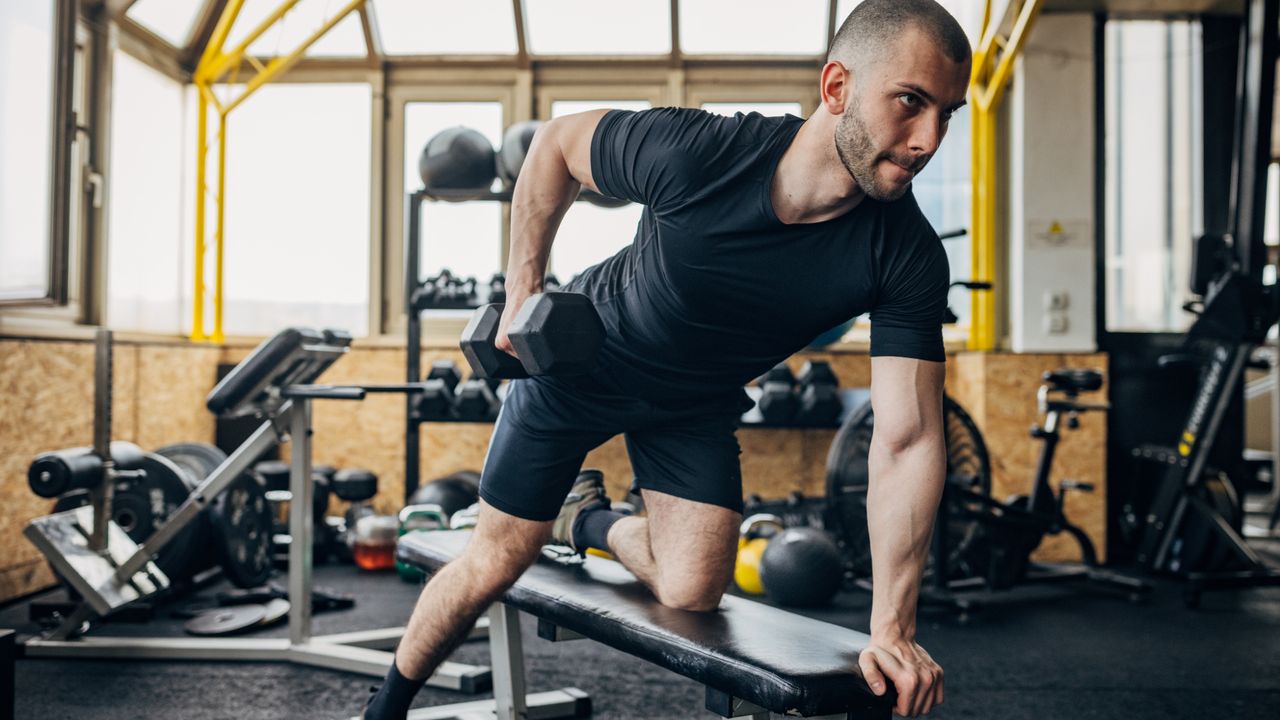 Man performing bent-over dumbbell rows