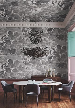 wallpaper on walls and ceiling in dining room, retro dining table and chairs, black chandelier