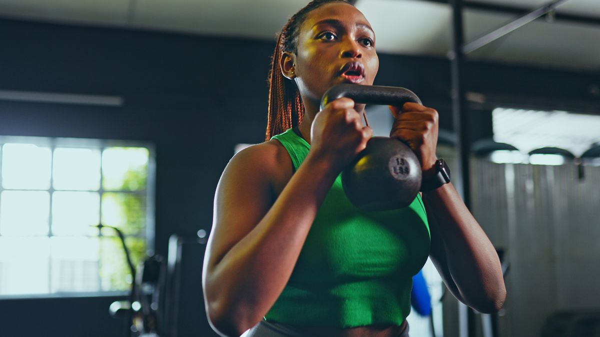 Woman holds kettlebell