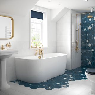 blue and white bathroom with patterned floor and wall tiles around bath and in shower
