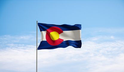 Colorado state flag against blue sky