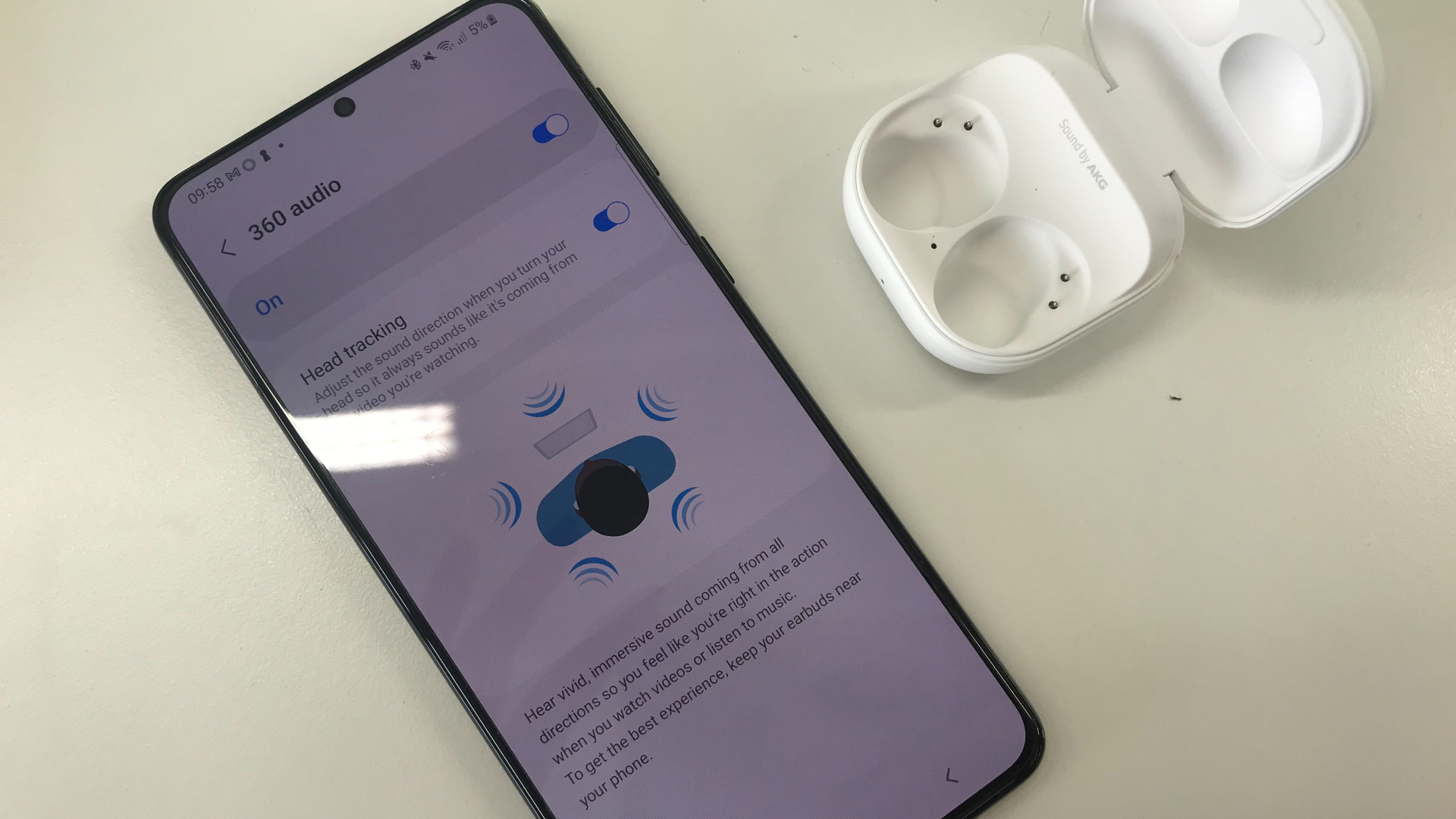 Samsung Galaxy Buds 2 Pro and a phone showing the Samsung Wearable app