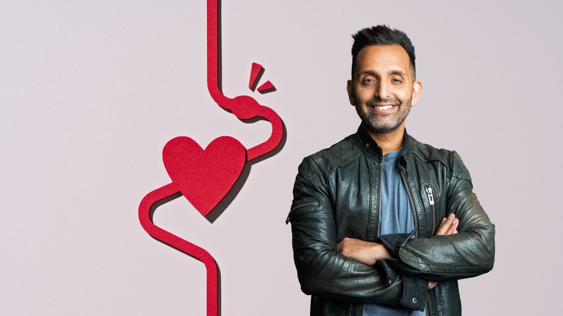 Dr Amir Khan next to heart representing importance of lower cholesterol levels