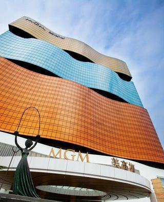The MGM's facade with a statue at the bottom and orang, blue and grey waves to the building's upper design.