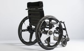 Black wheelchair photographed against a white background