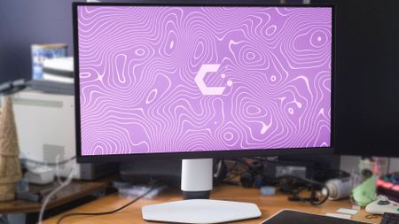 BenQ Mobiuz EX271UZ monitor on desk with purple CatchyOS wallpaper on screen.