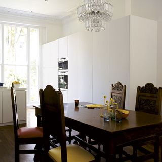 kitchen with dinning table and chandelier with chair