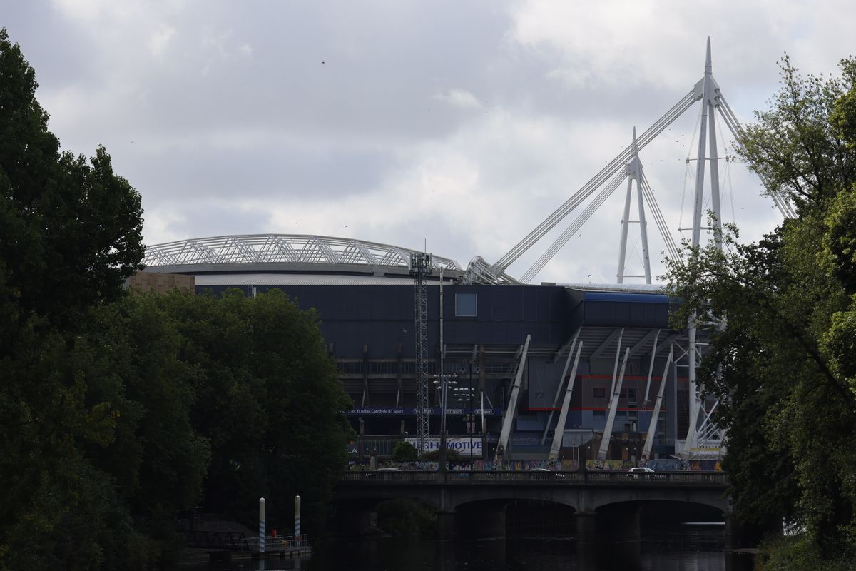 The roof of a stadium in front of a cloudy sky