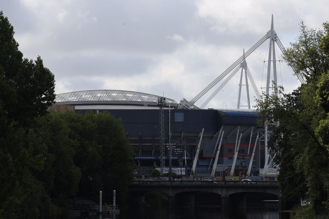 The roof of a stadium in front of a cloudy sky