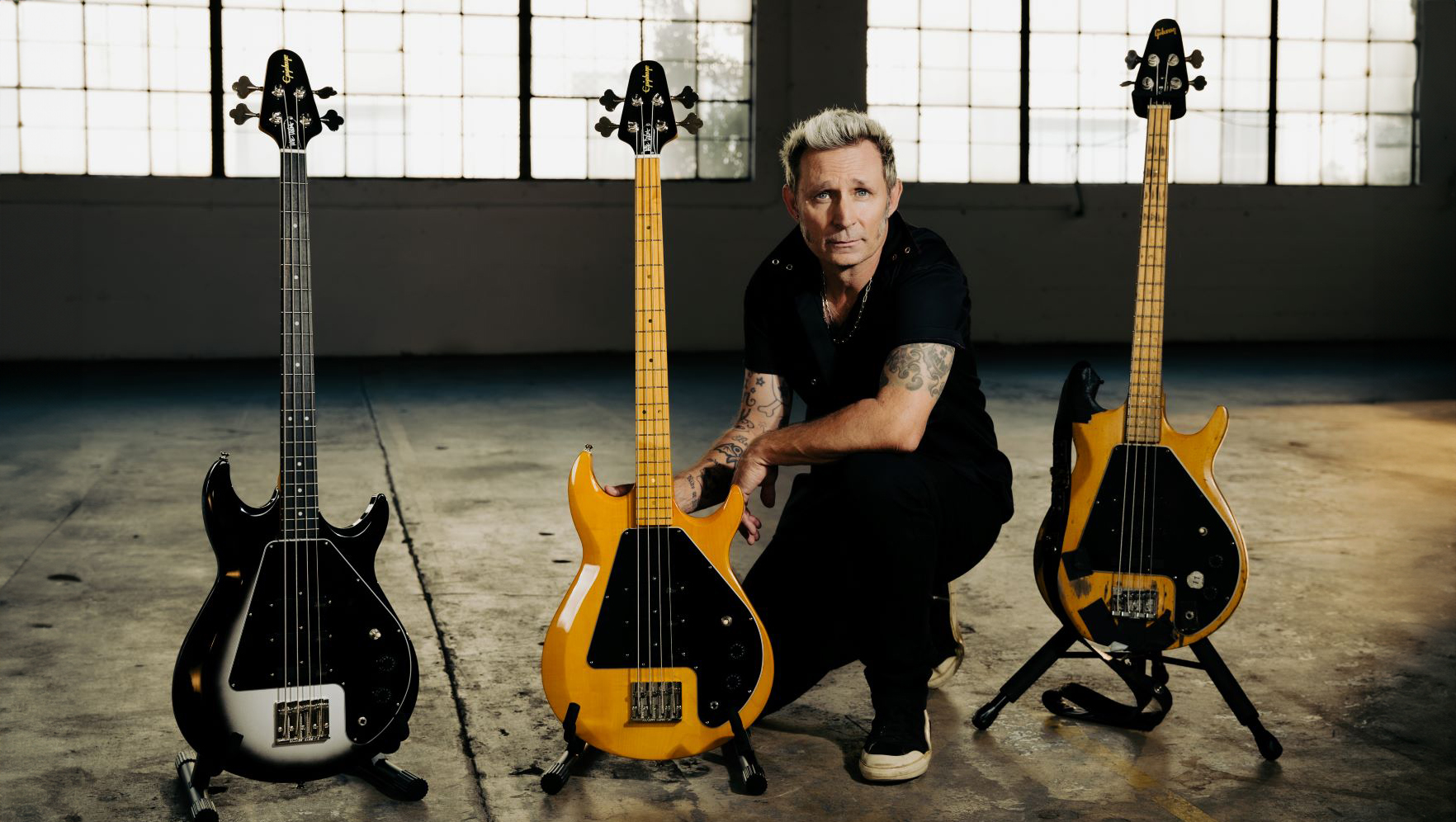 Mike Dirnt poses with his signature Epiphone Grabber Bass