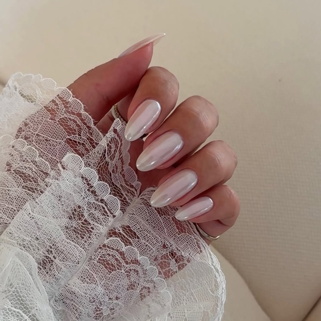 A hand with a glazed engagement manicure.