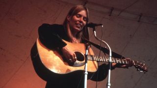 Joni Mitchell performs at the Central Park Music Festival in New York, New York in 1969