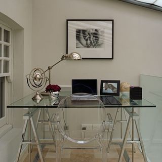 home office with glass topped table and wooden flooring