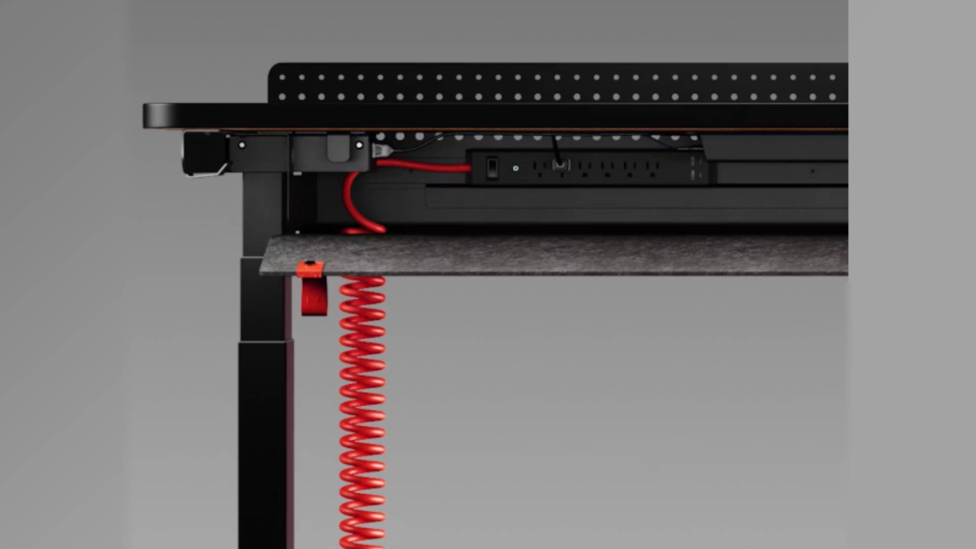 Close up of Herman Miller Coyl under wiring with red wire leading to extension lead.