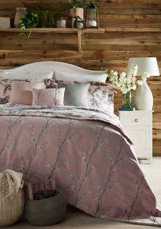 rustic bedroom with wood panelling and wooden shelf