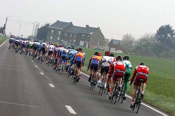 The peloton arrives at the outskirts of a village