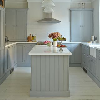 blue kitchen with central island and white floors