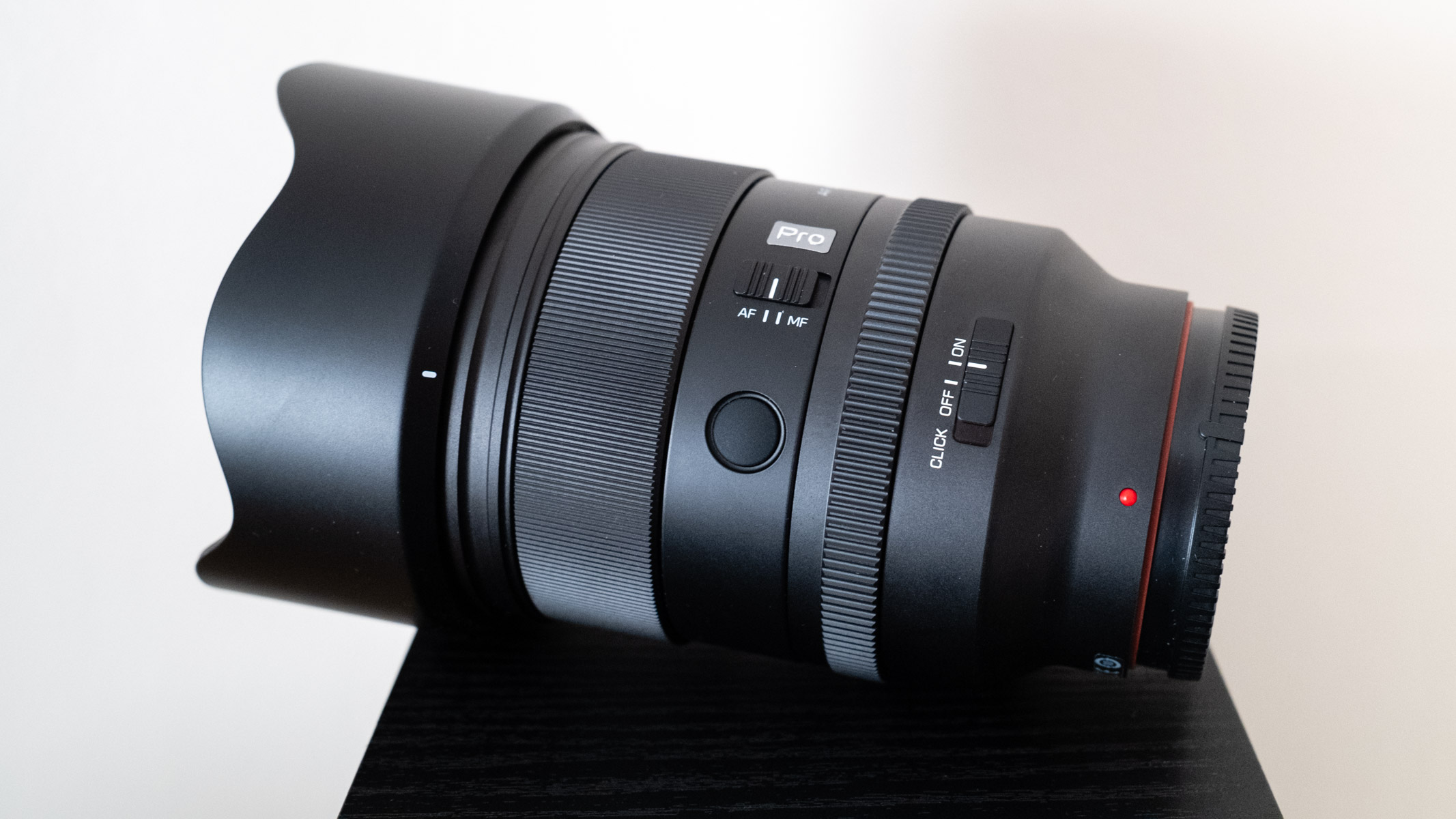 Viltrox AF 50mm f/1.4 Pro FE side view of controls with the lens hood attached