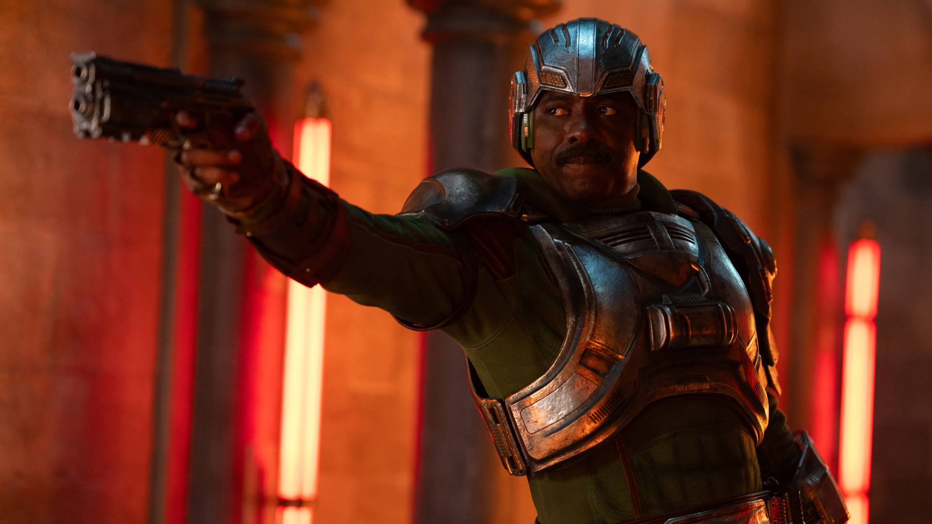 Idris Elba as Duncan/Man-At-Arms holding a gun in Masters of the Universe