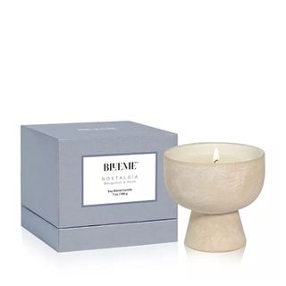scented candle in ceramic vessel with tall foot
