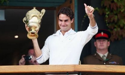 Swiss tennis great Roger Federer holds up his trophy after winning his record-tying seventh Wimbledon title on Sunday. Federer defeated British player Andy Murray.