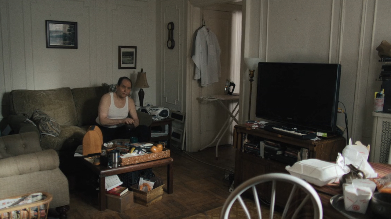 Mike sitting in his messy apartment in The Chair Company Episode 5